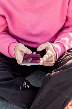 close up of the hand of a young man using mobile phone to scroll through social media, concept of technology of communication and modern lifestyle
