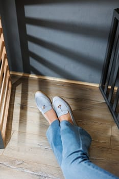 Slender female legs in jeans and blue loafers. Collection of summer women's shoes. Stylish women's shoes for summer