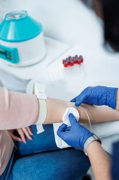 Medical procedure. Taking blood from a vein into a test tube. Sterile blood collection