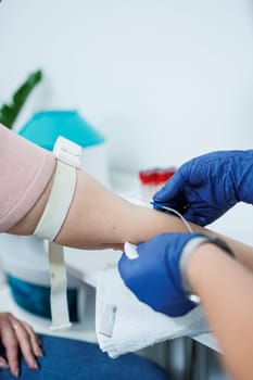 Medical procedure. Taking blood from a vein into a test tube. Sterile blood collection