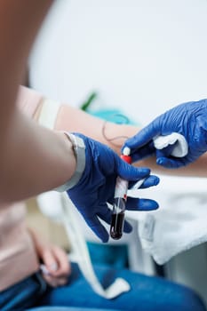 Medical procedure. Taking blood from a vein into a test tube. Sterile blood collection