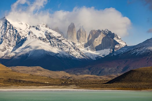 View over the mountain range of the Torres del Paine massif in front of the green turquoise lagoon Amarga in southern Chile, Patagonia, Torres del Paine National Park, South America