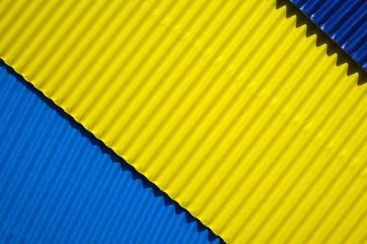 Diagonally ribbed cardboard with the colors blue, yellow, indigo. Meant as background