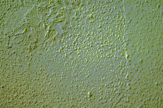 Wall painted with moss green grained textured paint. Green-grey wall structure. Meant as background