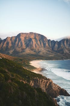 Nature at its finest. a mountain range near the sea during a clear day outdoors