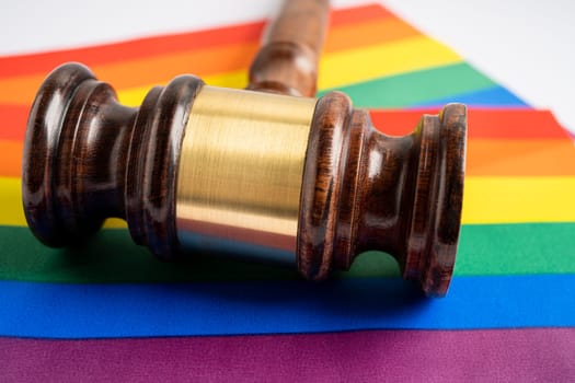 Gavel for judge lawyer on rainbow flag, symbol of LGBT pride month celebrate annual in June social of gay, lesbian, bisexual, transgender, human rights.