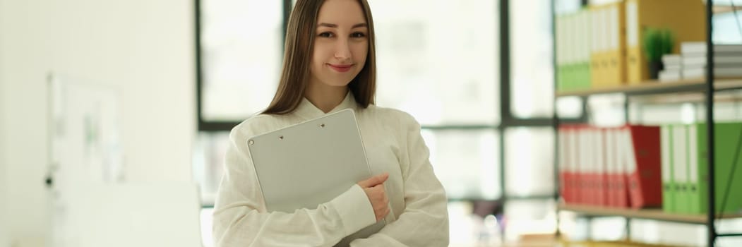 Woman manager with clipboard in hands in office portrait. Professional career growth in business concept