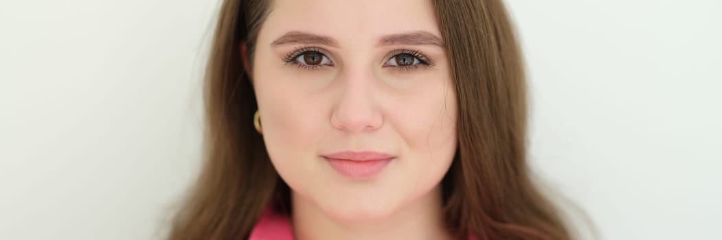 Portrait of young beautiful woman with dark long hair. Ordinary people concept