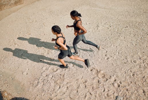 Fitness friends running on the beach, women workout together with cardio and active body on sand outdoor. Exercise in nature, healthy and top view of female people training with run and mockup space.