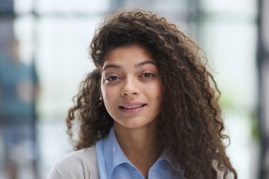 Portrait of young smiling woman looking at camera