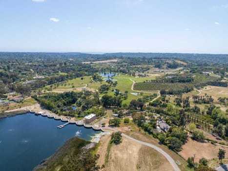 Aerial view over water reservoir and a large dam that holds water. Rancho Santa Fe in San Diego, California, USA