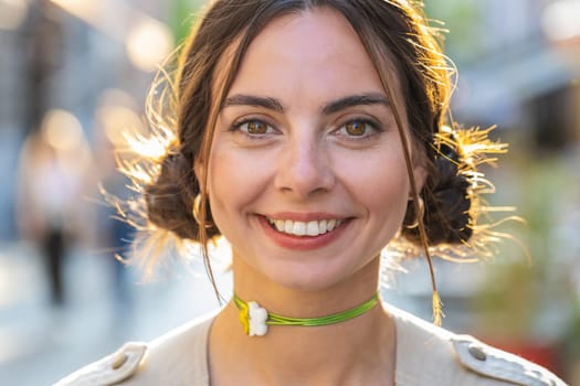 Close-up portrait of happy young woman face smiling friendly open eyes glad expression looking at camera dreaming resting relaxation feel satisfied good news outdoors. Pretty girl in sunny city street