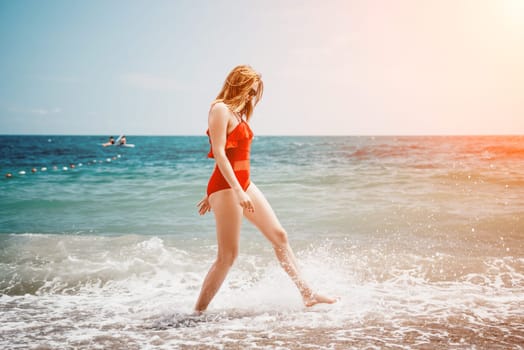 Pretty young blonde woman walking on the beach in summer, having fun, walks carefree on the seaside . Portrait beautiful young woman relax smile around beach sea ocean in holiday vacation travel trip.