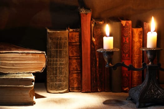 Nice vintage candlestick on background with old books