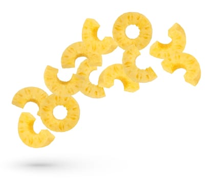 Falling pineapple rings on a white isolated background. Juicy rings of ripe pineapples of different cuts scatter in different directions. Isolate of pineapple rings of different cutting methods