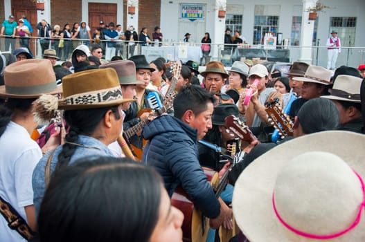 Otavalo, Ecuador - 24 de junio de 2023: indigenous men playing songs with guitars and mandolins in the plaza of otavalo. High quality photo