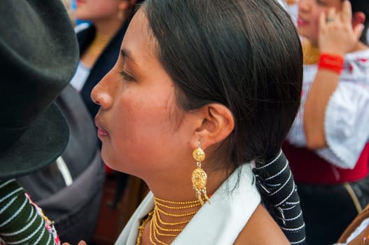 Otavalo, Ecuador - 24 de junio de 2023: closeup of young indigenous woman with her native traditional jewelry of her culture. High quality photo