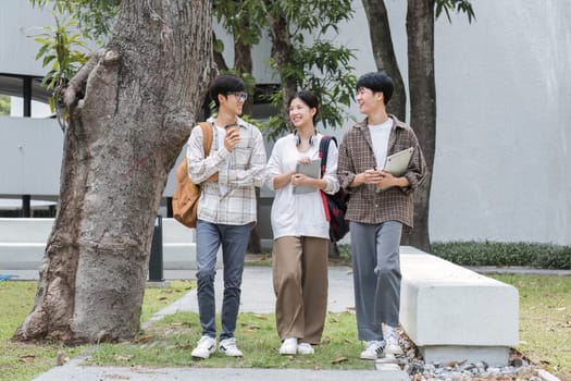 Outdoor of smiling university young group students college man and women students college smiling stand holding books and laptop computers on campus, Education concept, Back to college concept..