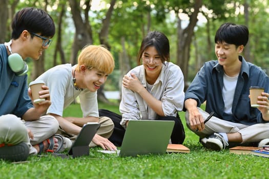 Image of university students talking and laughing together in campus. Friendship, youth lifestyle and education concept.