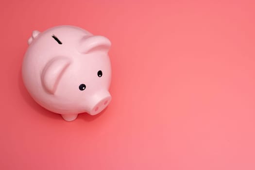 Pink piggy bank on pink background. Money and business. Money saving.