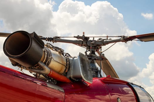 Fragment of a helicopter. Helicopter propeller against a cloudy sky. Helicopter propeller. Part of copter rotor.