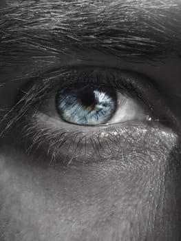 Black and white photo of the blue colored of the iris of the eye. Man eye images.