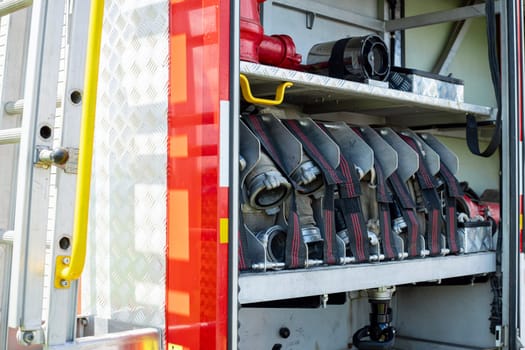 Fire truck equipment. Compartment of the rolled up fire hoses on a fire engine.