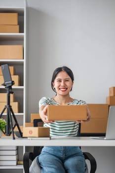Starting Small business entrepreneur SME freelance, Portrait young woman working at home office, BOX, smartphone, laptop, online, marketing, packaging, delivery, b2b, SME, e-commerce concept