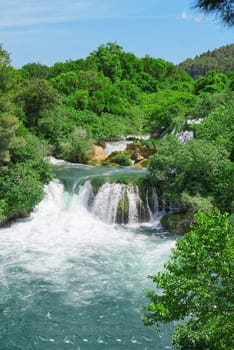 Beautiful Waterfall background in sunny summer day. Beautiful Waterfall In Krka National Park - Croatia, Europe. Krka river waterfalls in the Krka National Park