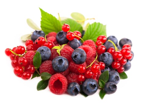 Handful of berries blueberries, raspberries, currants and strawberries isolated on a white