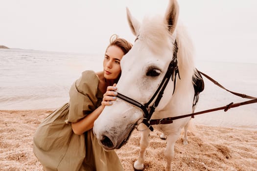 A white horse and a woman in a dress stand on a beach, with the sky and sea creating a picturesque backdrop for the scene