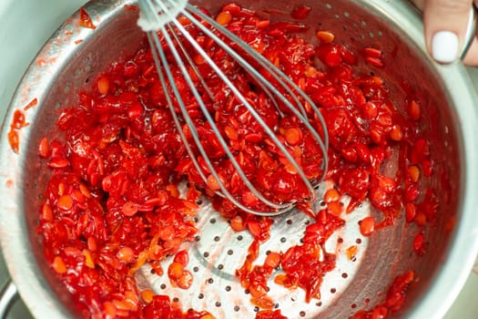 Making jam and separating seeds from guelder rose berries