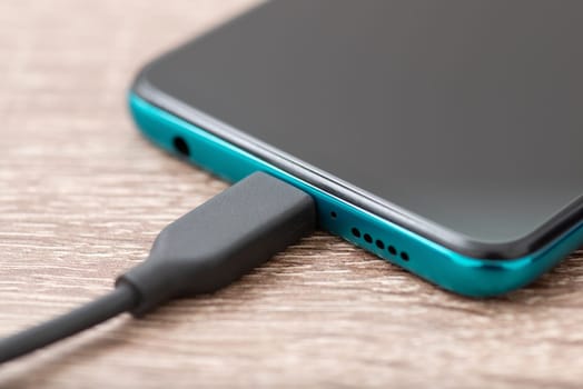 Close up photo of phone with connected usb cable