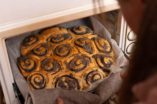 Cooking at home concept, tasty buns with poppy seed