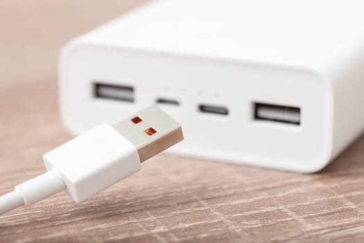 Close up of power bank with usb type-a cable on the foreground