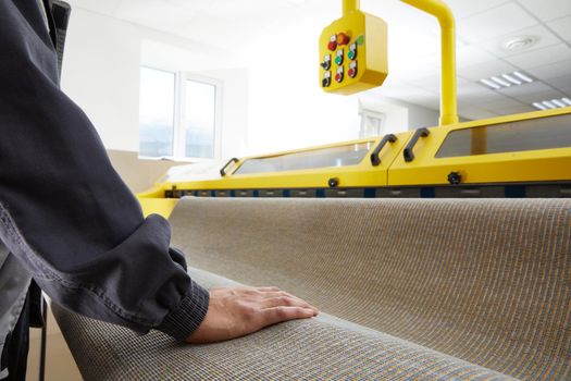 Man worker cleaning carpet on automatic washing machine equipment and dryer in the Laundry room