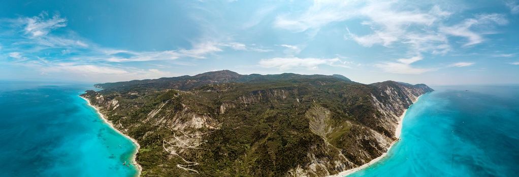 Aerial view on the sea coastline with beaches and mountains. Beautiful natural seascape at the summer time. View on the west coast of the island of Lefkada, Greece.