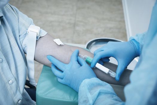 Nurse doing blood test from vein. Covid testing concept