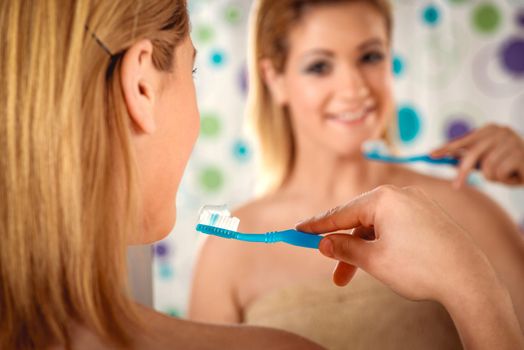 Young beautiful woman is ready to brush her healthy teeth. 