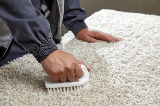 Man holding brush Removing Stain in professional cleaning service . High quality photo