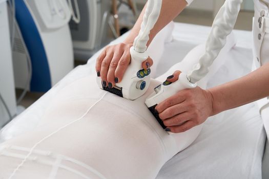 Beautiful woman getting beauty therapy against cellulite with LPG machine. LPG massage for lifting body