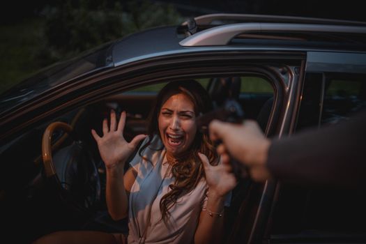 Bandit robbery woman with gun feeling shock and scared in car.