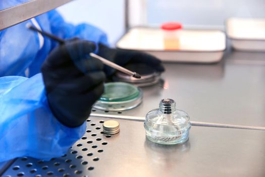 medical technologist doing urine test in medical laboratory wearing protective uniform. High quality photo