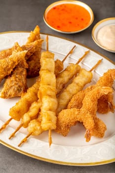 Seafood tempura with fish and shrimp on black stone table