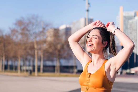 portrait of a beautiful woman in sportswear laughing happy, concept of active lifestyle and urban sport, copy space for text