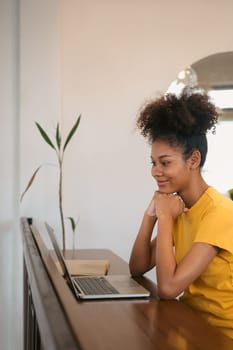 Interested university student looking at laptop screen, watching webinar, online course, doing homework.