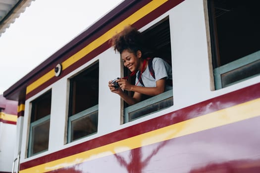 Tourists african american are showing happy expressions while waiting for their journey in the train station