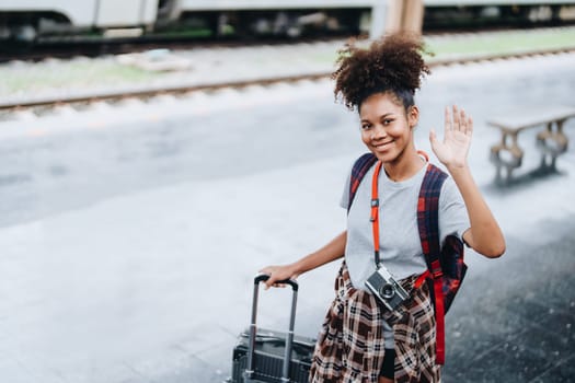 Tourists african american are showing happy expressions while waiting for their journey in the train station