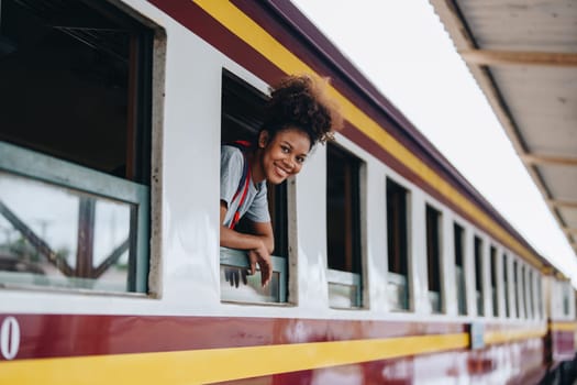 Tourists african american are showing happy expressions while waiting for their journey in the train station