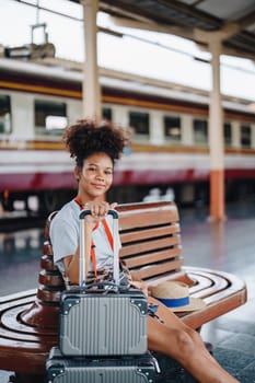 Tourists african american are showing happy expressions while waiting for their journey in the train station